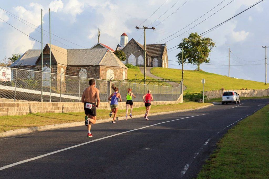 Runners on the road toward St Thomas Church on Nevis